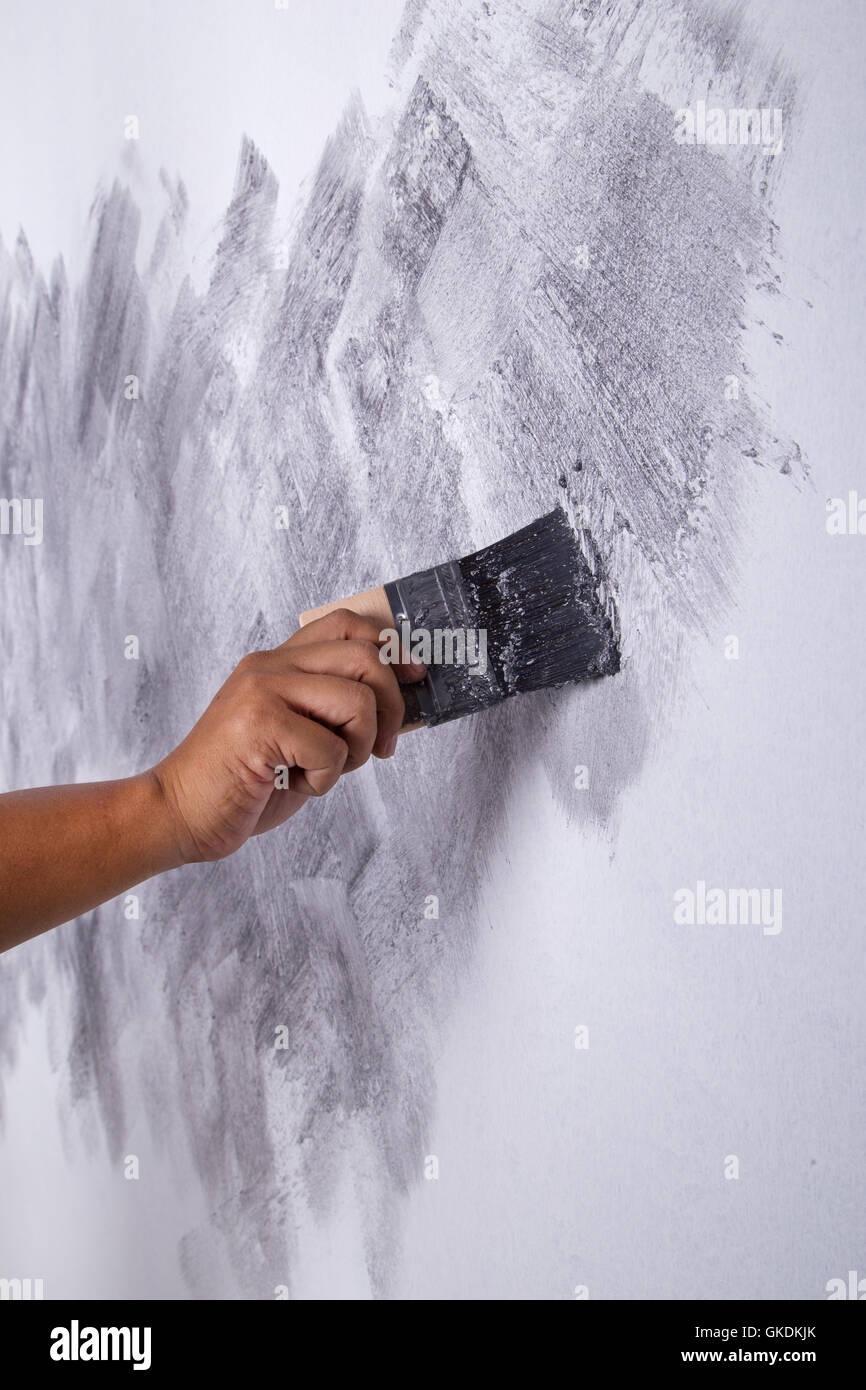 hand of worker use brush for color paint concrete Loft style on wall