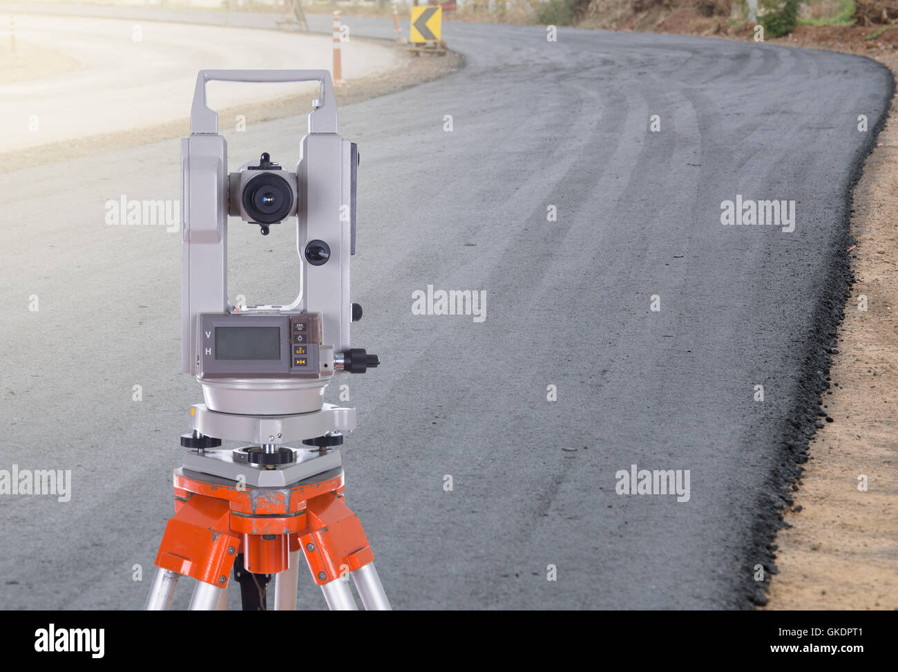 Survey equipment theodolite on a tripod.  with road under construction background Stock Photo