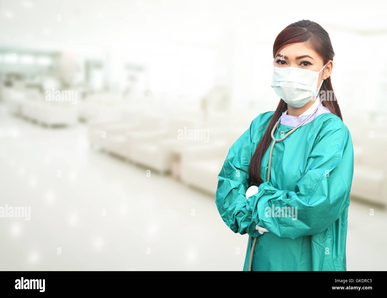 female doctor wearing a green scrubs and stethoscope in hospital ...