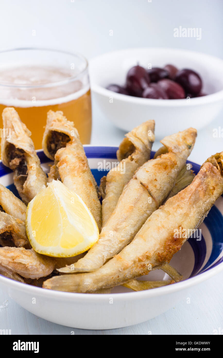 Fried ladyfish with lemon, olives and glass of beer Stock Photo Alamy