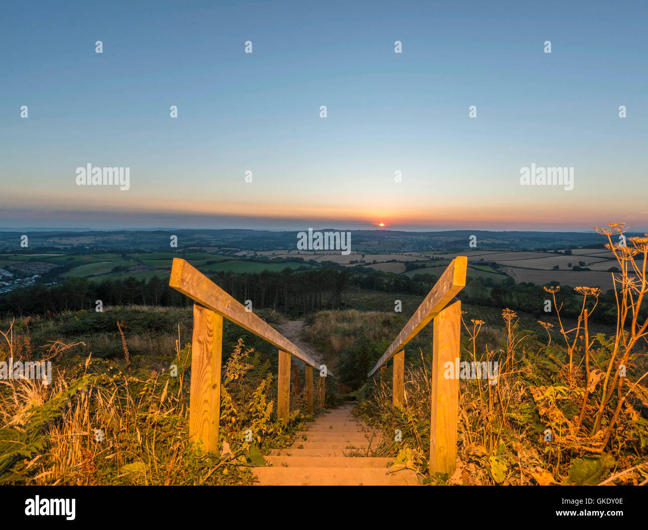 Landscape depicting the sunset over Devon countryside. Image taken at High Point wooden staircase viewing platform, Ladram Bay Stock Photo