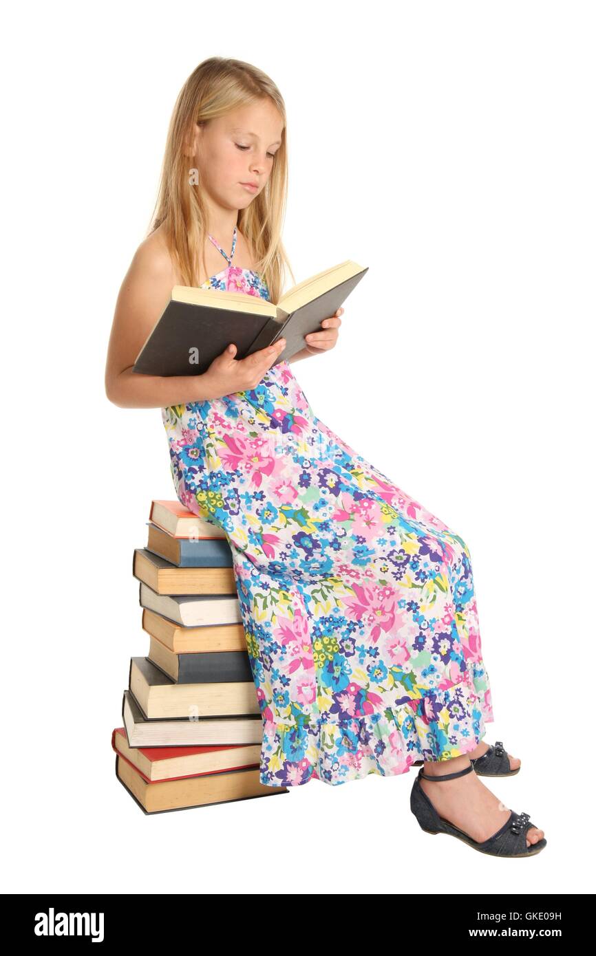 Cute School Girl Sitting on Books Stock Photo - Alamy