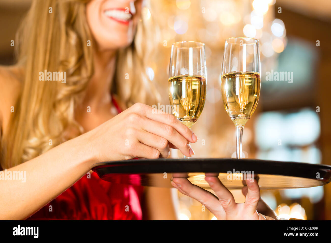 waiter serving champagne glasses on tray Stock Photo Alamy