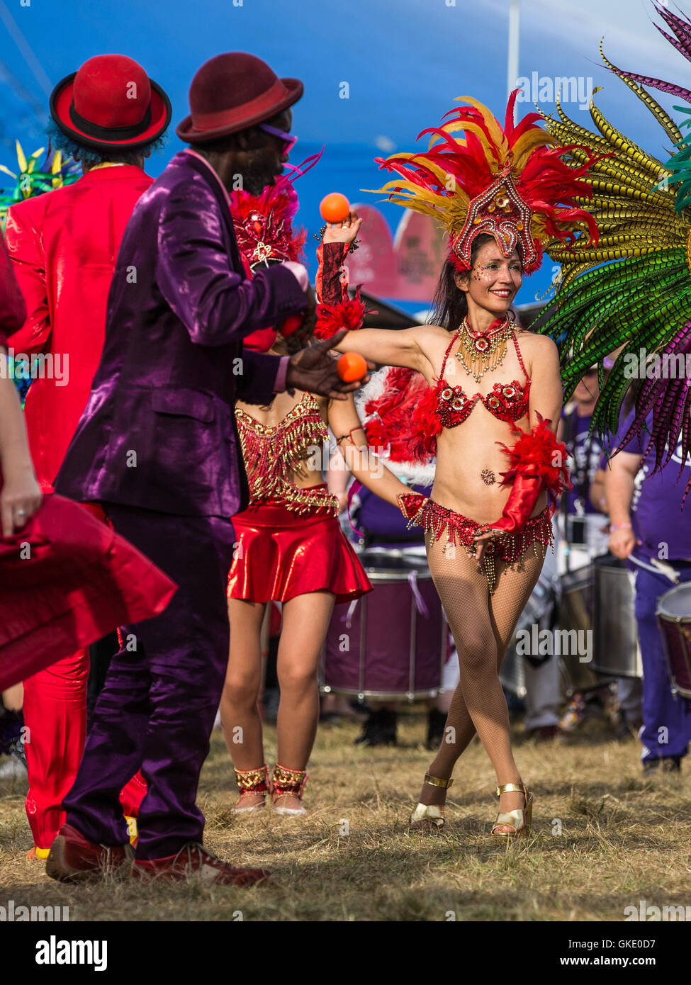 Colourful street performers at a parade during WOMAD festival Stock