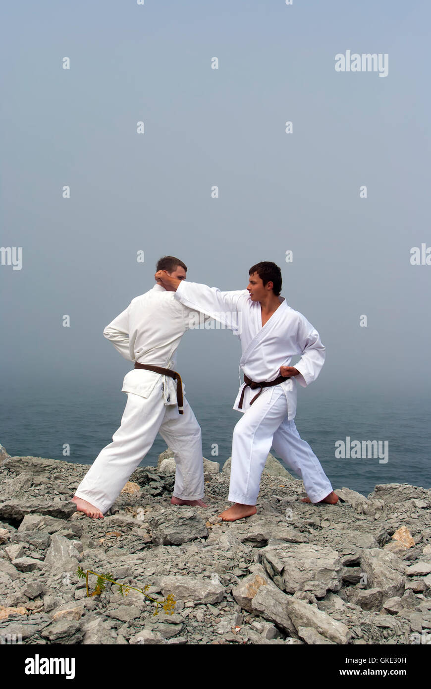 two karateka fight on the banks of the misty sea Stock Photo Alamy