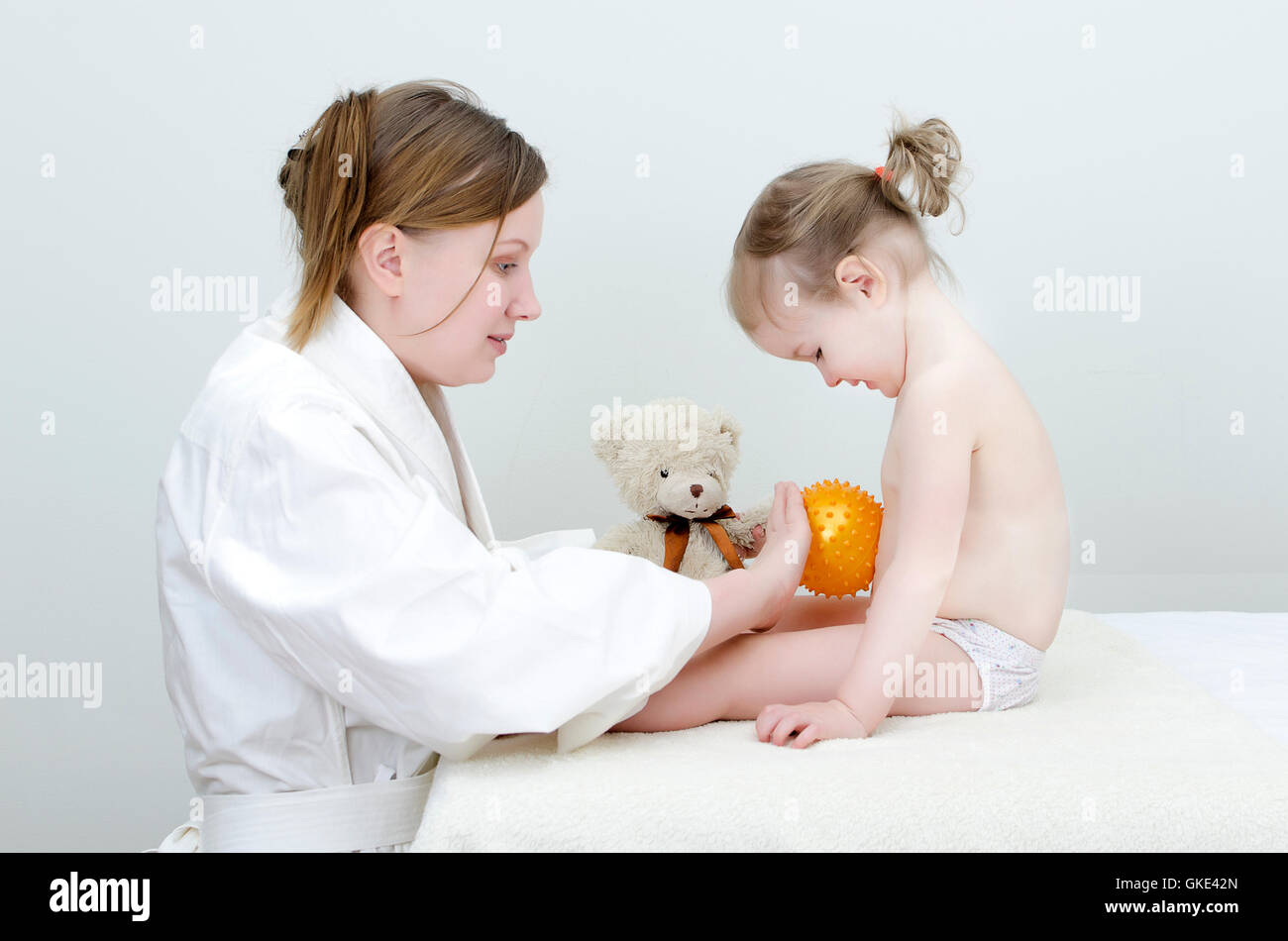 Therapist makes a child massage Stock Photo - Alamy