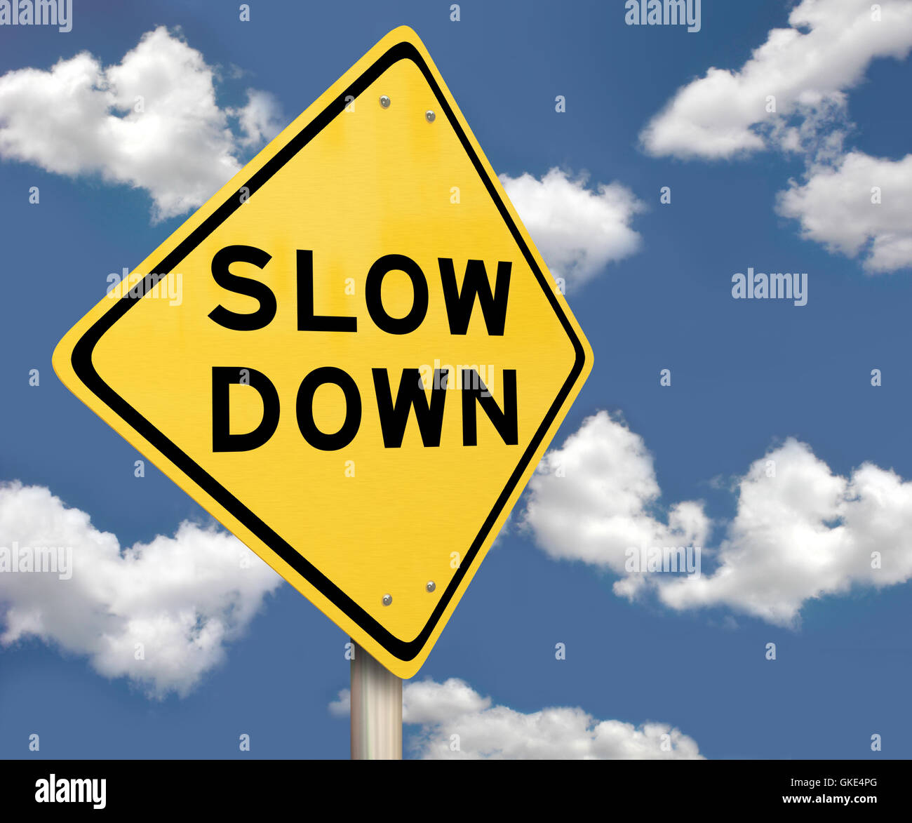 Yellow Warning Sign - Slow Down - Blue Sky Stock Photo