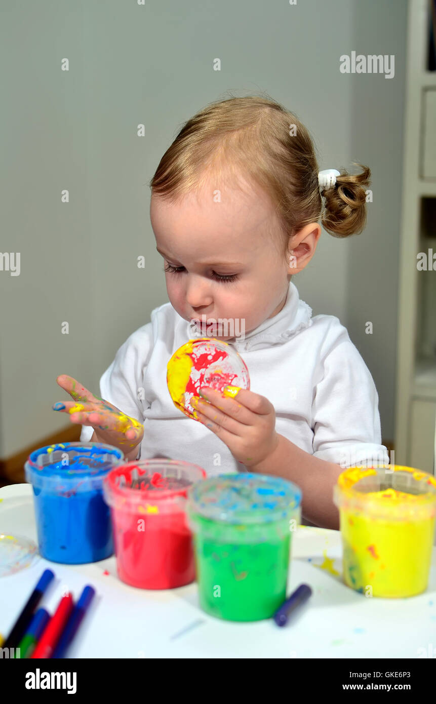 Kid Using Ink little girl draws with colored inks Stock Photo - Alamy