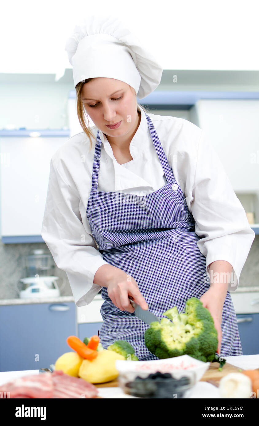 Attractive chief cook preparing food Stock Photo - Alamy