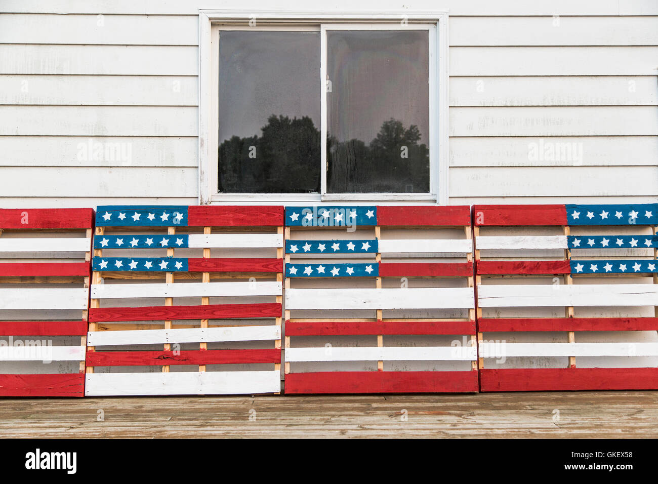 A patriotic display of wooden pallets painted in American flag motifs in red, white, and blue. Stock Photo