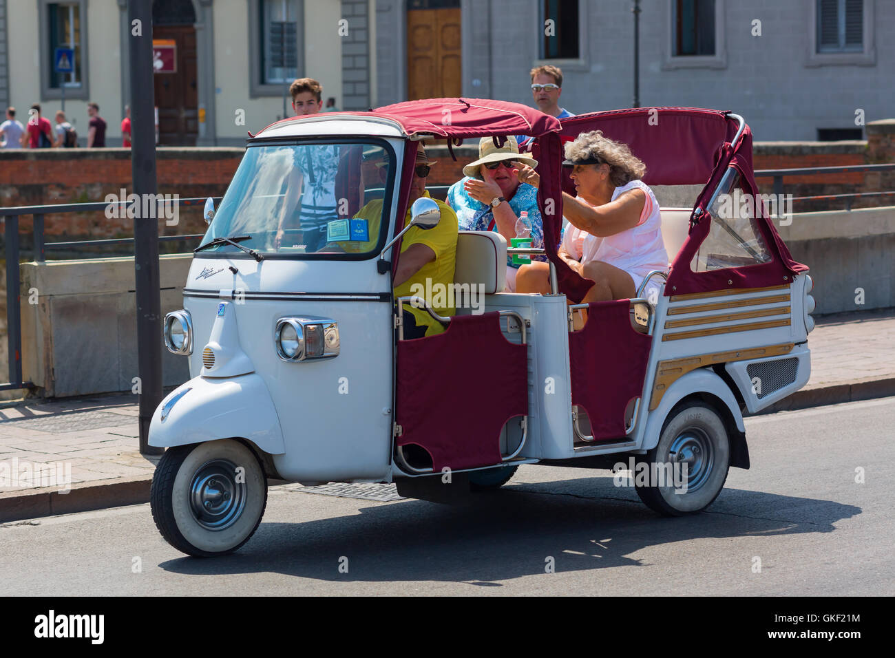 Florence, Italy - July 04, 2016: historic Piaggio Ape with unidentified people in Florence. The Ape is a three-wheeled light com Stock Photo