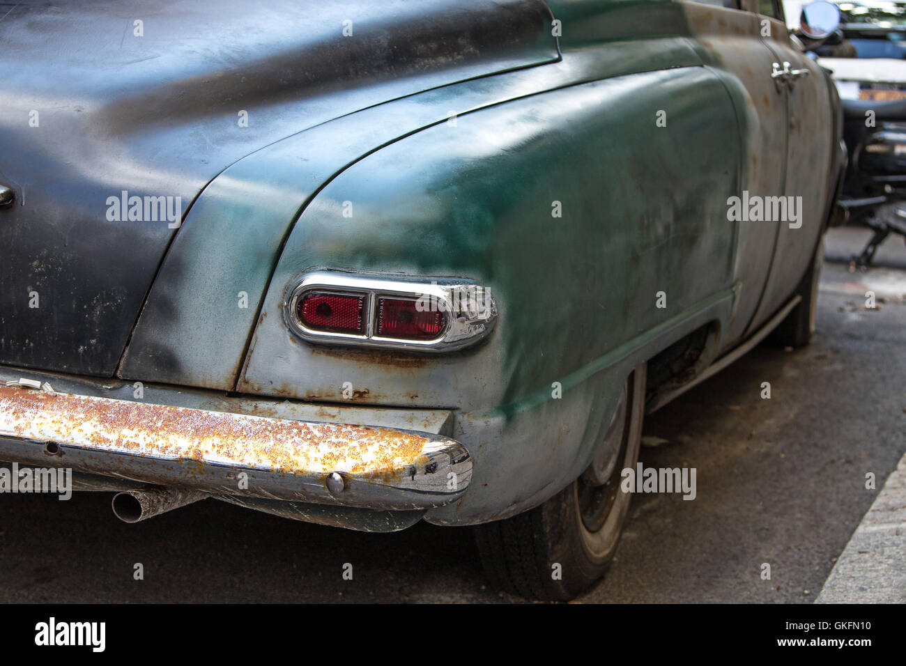 Rear view of an old vintage car in need of restoration. Stock Photo
