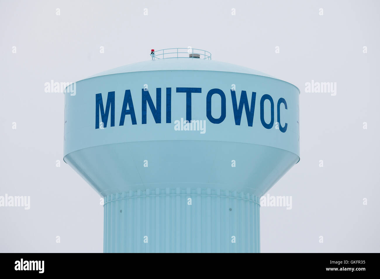 A large blue water tower with a winter sky in the city of Manitowoc, Wisconsin. Stock Photo