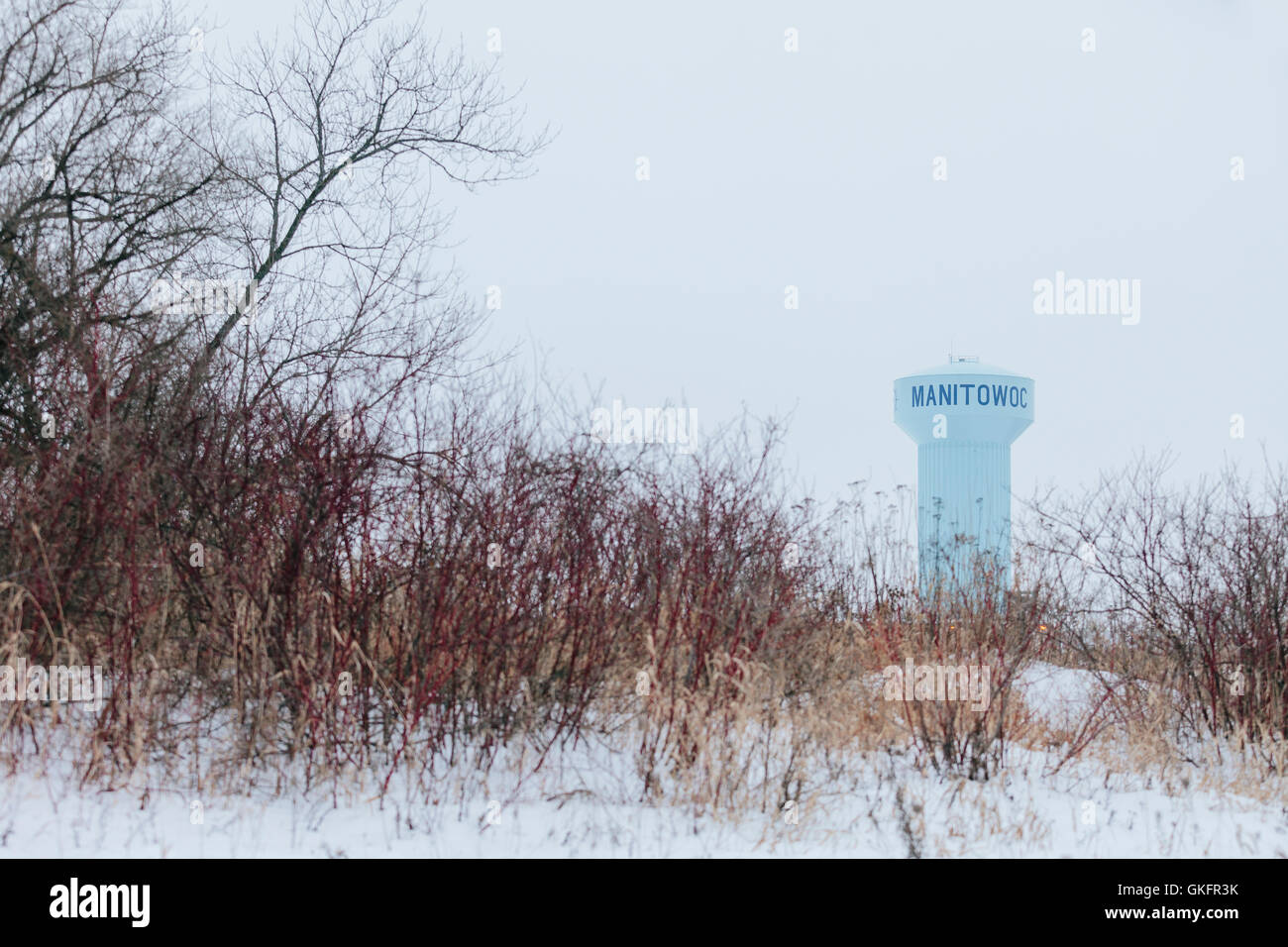 A large blue water tower with a winter sky in the city of Manitowoc