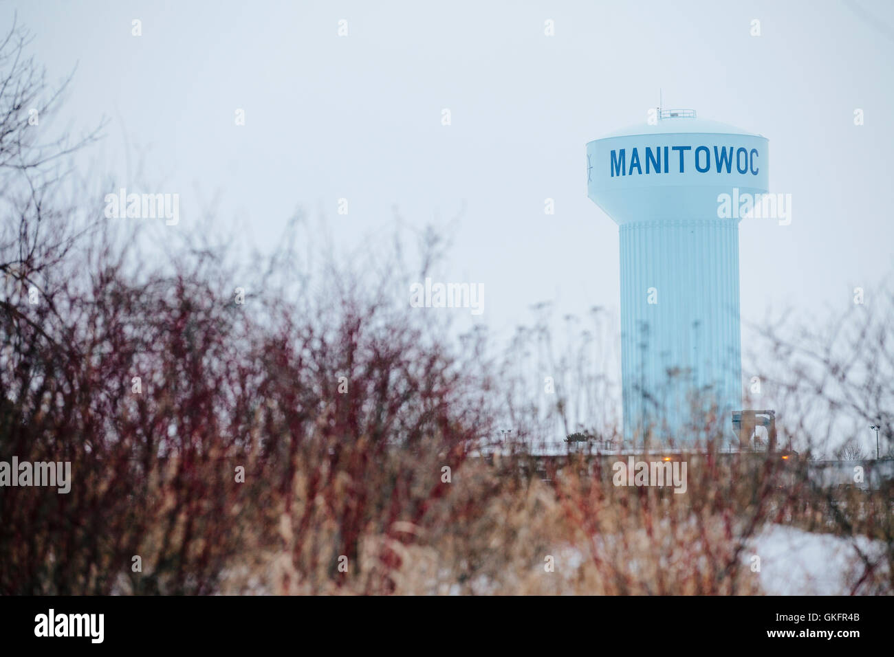 A large blue water tower with a winter sky in the city of Manitowoc