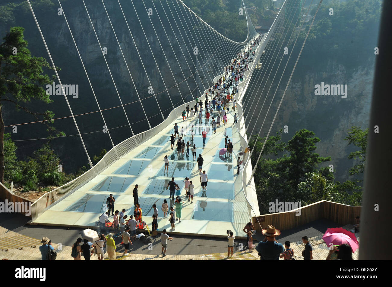 Zhangjiajie, China's Hunan Province. 20th Aug, 2016. Photo taken on Aug. 20, 2016 shows the aerial view of Zhangjiajie Grand Canyon's glass-bottom bridge in Zhangjiajie scenic spot, central China's Hunan Province, Aug. 20, 2016. Zhangjiajie Grand Canyon's glass-bottom bridge was put into trial operation here on Saturday. Spanning two cliffs in the canyon area, the bridge stretch 430 meters long and 6 meters wide, hovering over a 300-meter-deep valley. The bridge deck is paved with transparent glasses and can accommodate up to 800 people at a time. Credit:  Long Hongtao/Xinhua/Alamy Live News Stock Photo