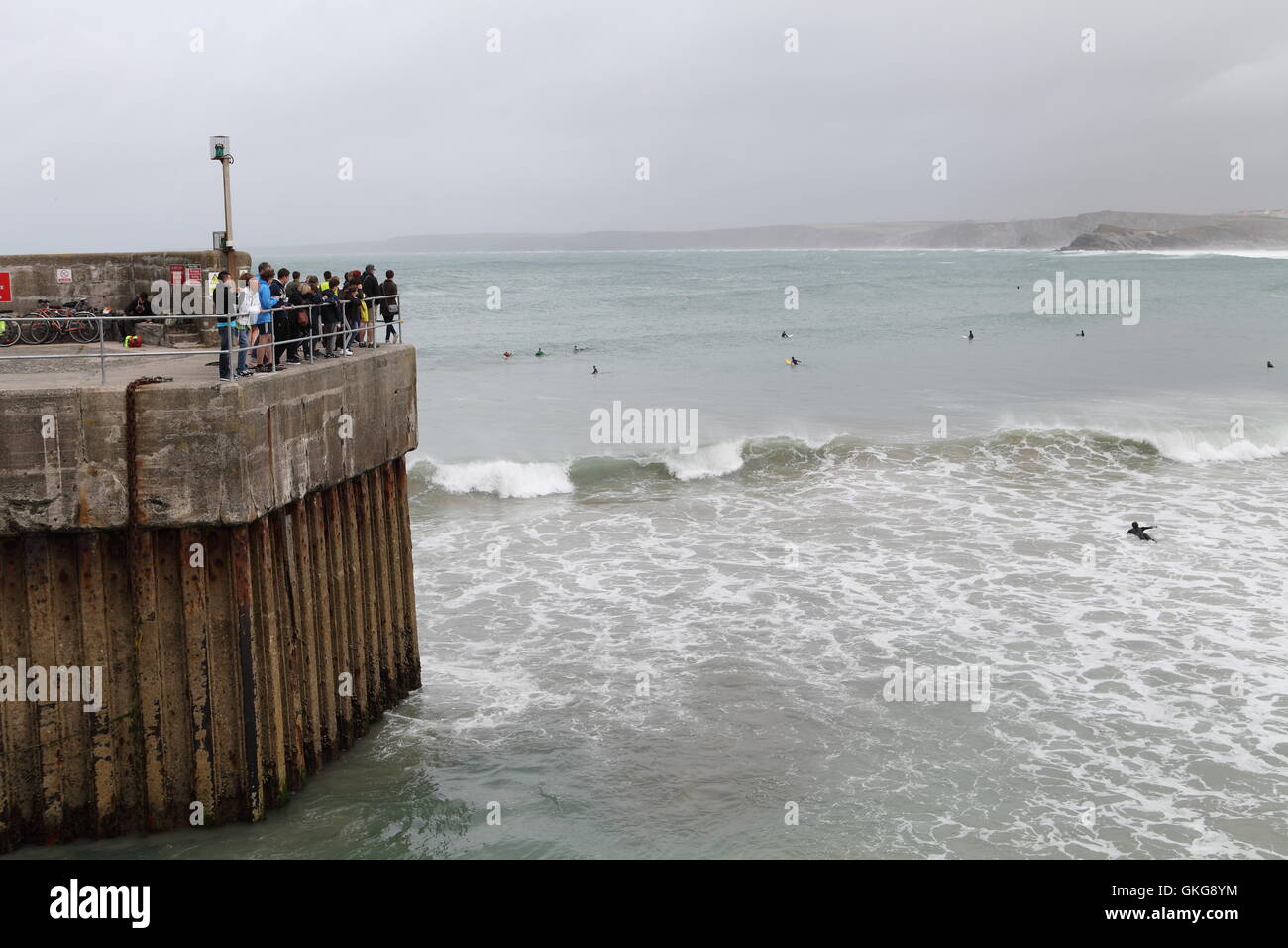 TOWAN BEACH, NEWQUAY, CORNWALL, UK - August 20, 2016: Gale force winds produce large waves enjoyed by surfers at Towan Beach. Newquay is one of the major surfing tourist attractions in the UK. Stock Photo