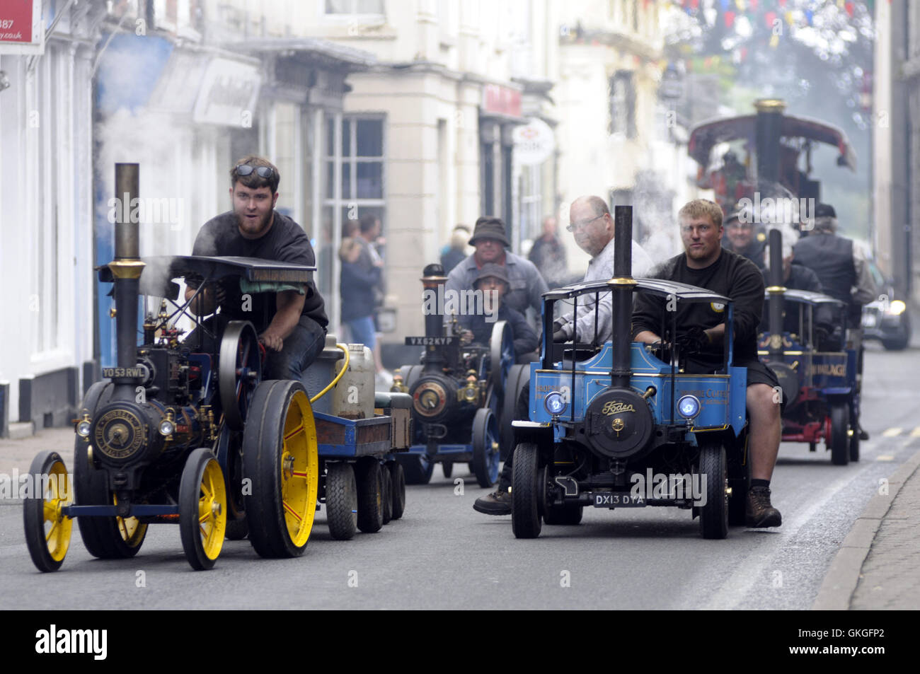 Kington, Herefordshire, UK. 21st August 2016.  A line up of miniature steam engin's makes their way up Kington High Street. Credit:  Andrew Compton/Alamy Live News Stock Photo
