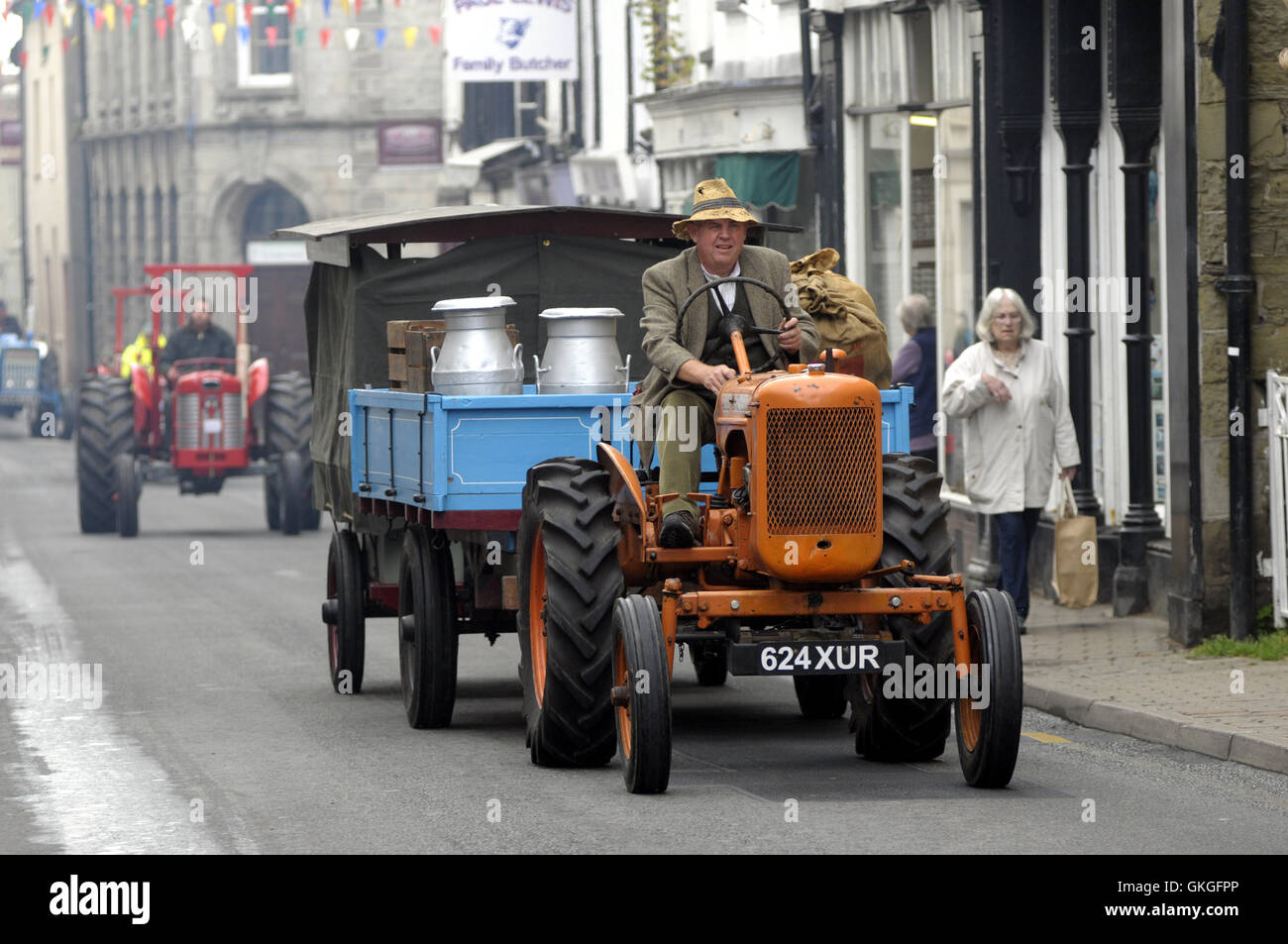 Kington, Herefordshire, UK. 21st August 2016.  A parade of vintage tractors make their way up Kington High Street. Credit:  Andrew Compton/Alamy Live News Stock Photo