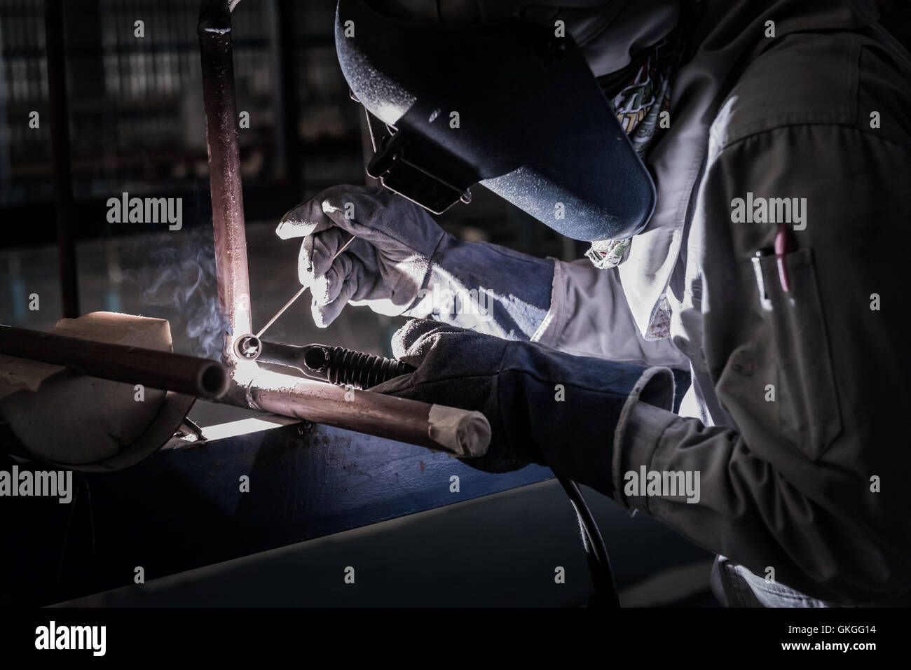 Welding steel pipe with Mig-Mag method for industrial work. Gas metal arc welding Stock Photo