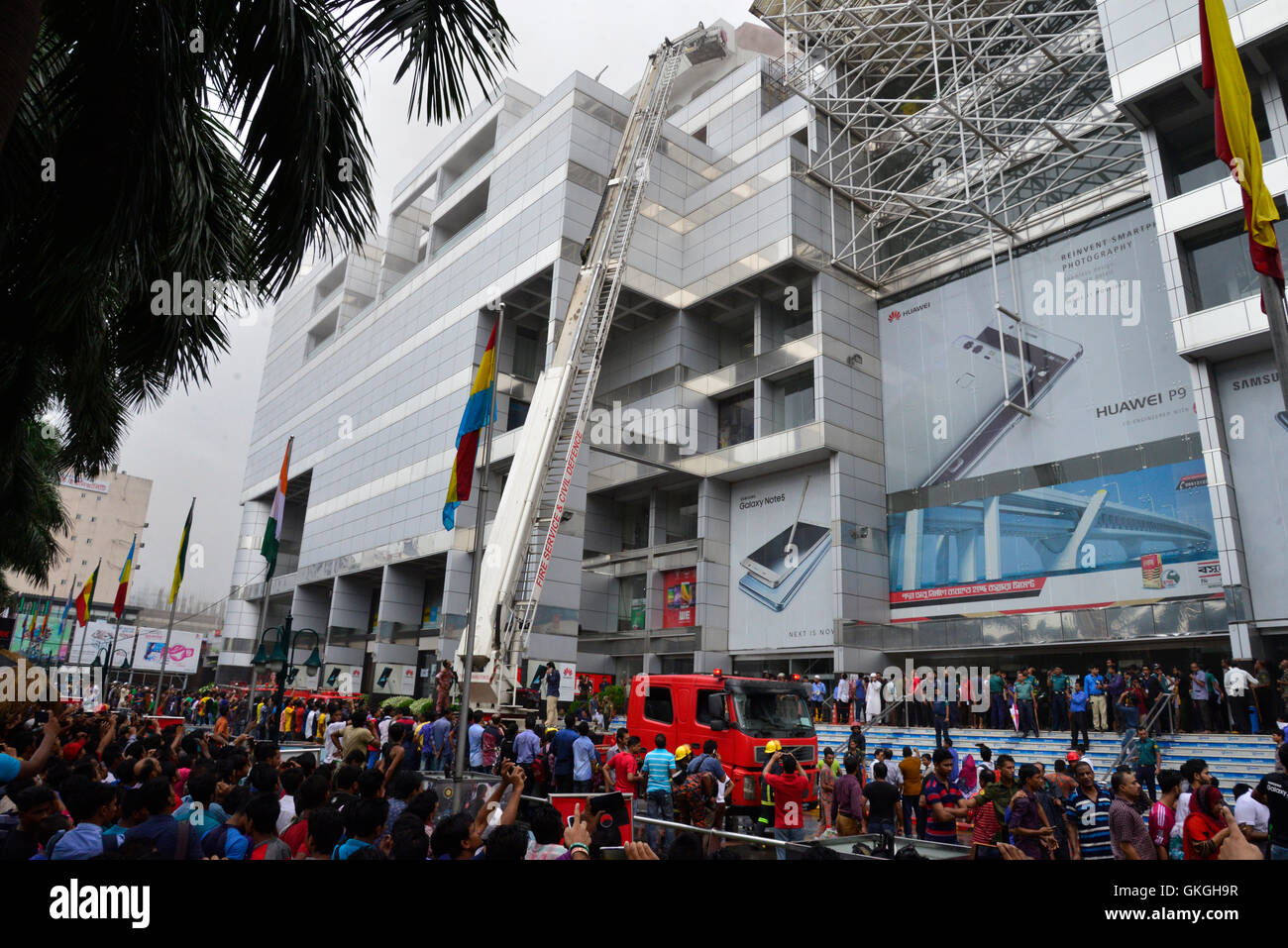 Bangladeshis gather to watch rescue operations outside of the Bashundhara City shopping mall that caught fire in Dhaka Bangladesh. On August 21 2016 Fourteen firefighting units are working to control ...