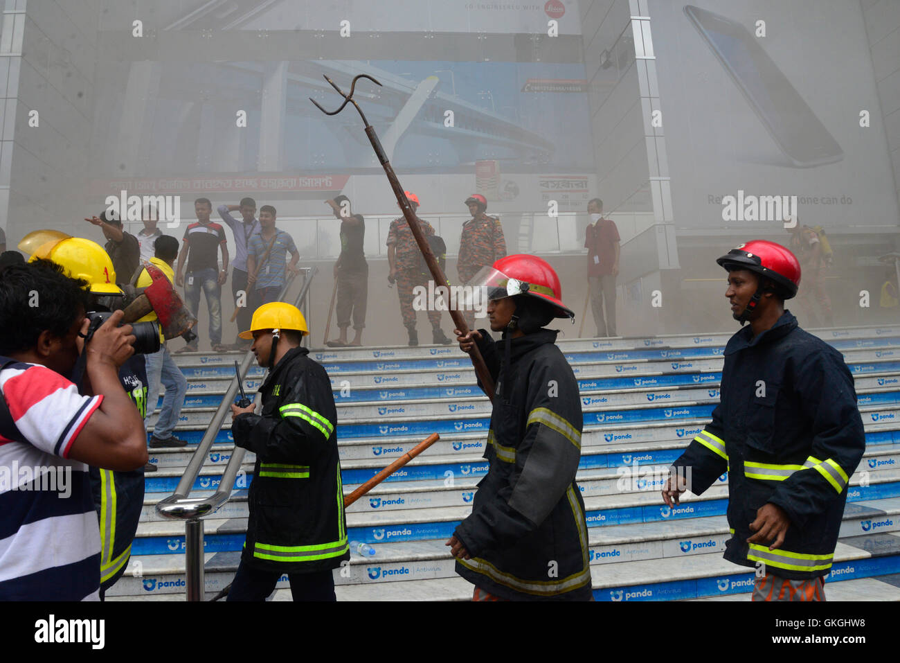 Bangladeshi firefighters work to douse a fire at the Bashundhara City ...