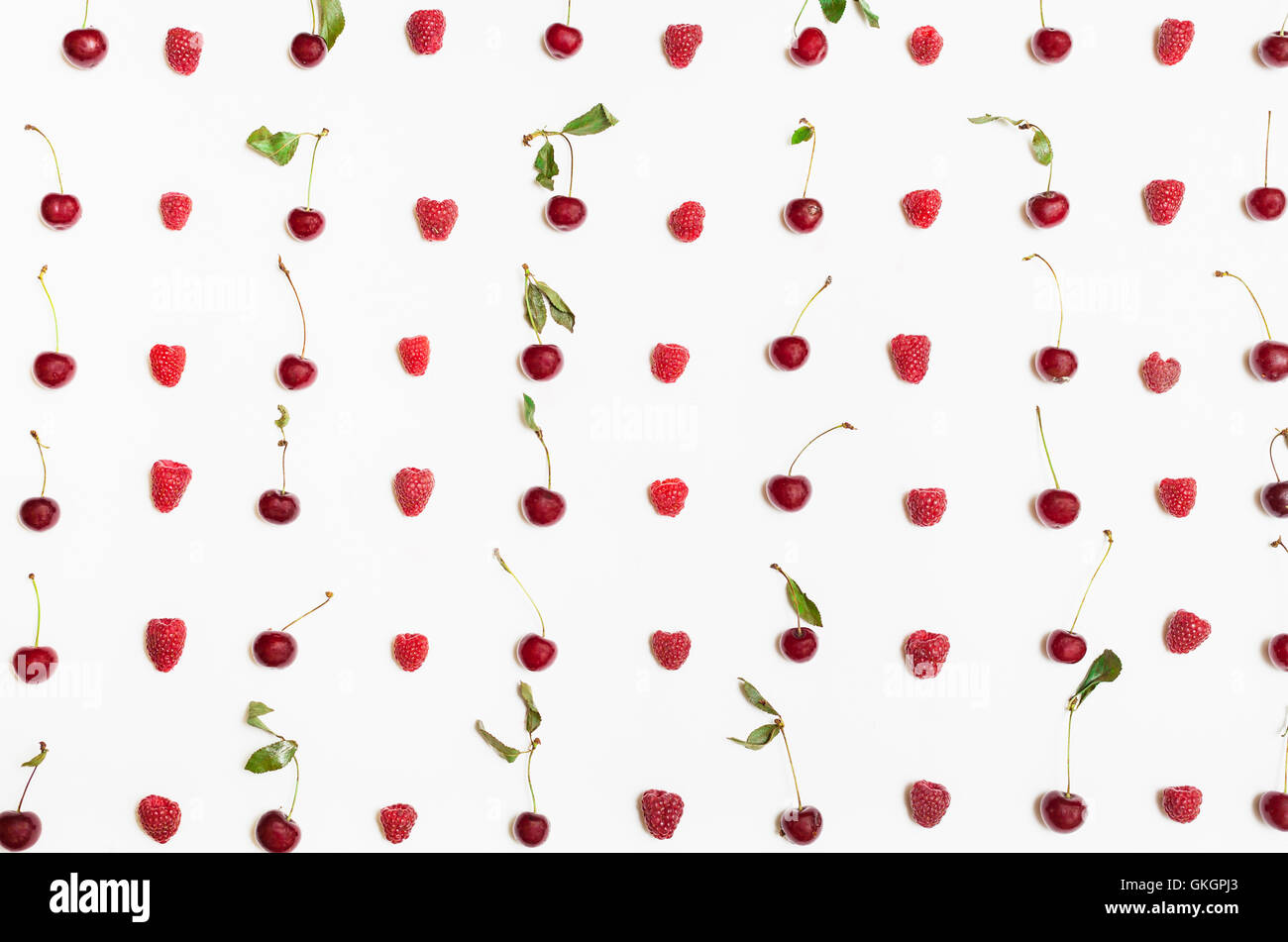 Cherry Vs Raspberry Size many raspberries and cherries arranged on white background Stock Photo ...