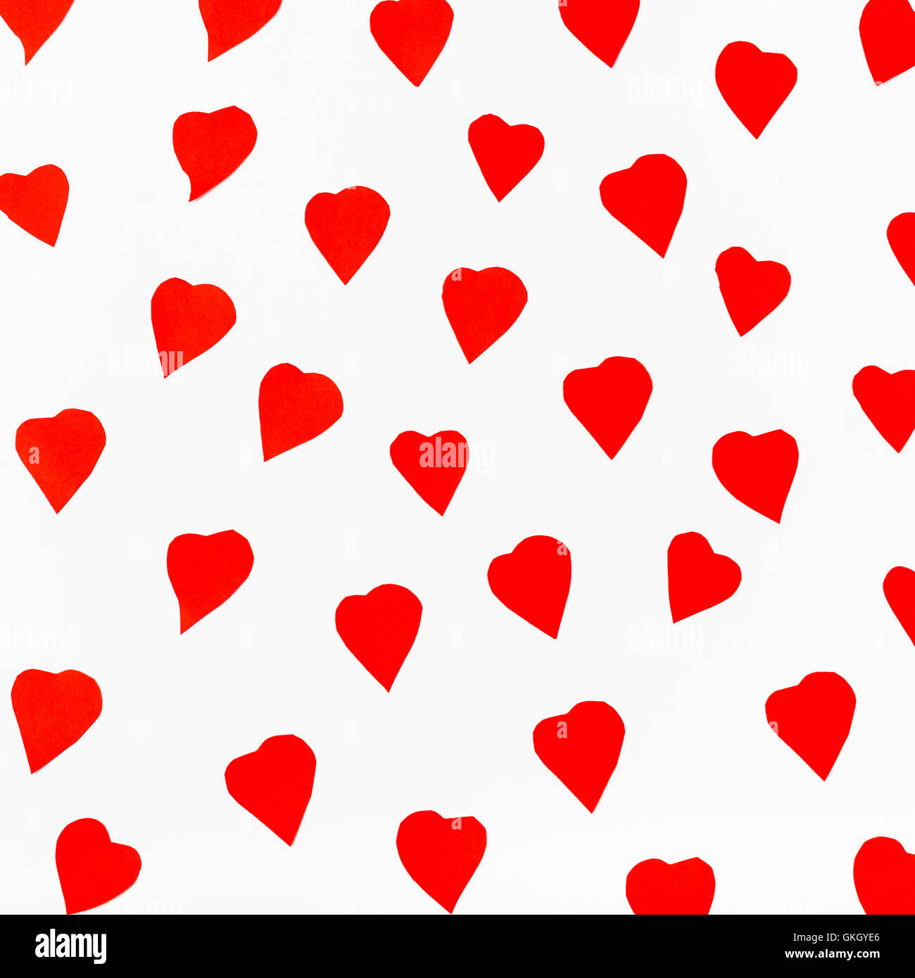 red hearts carved from paper on white background Stock Photo