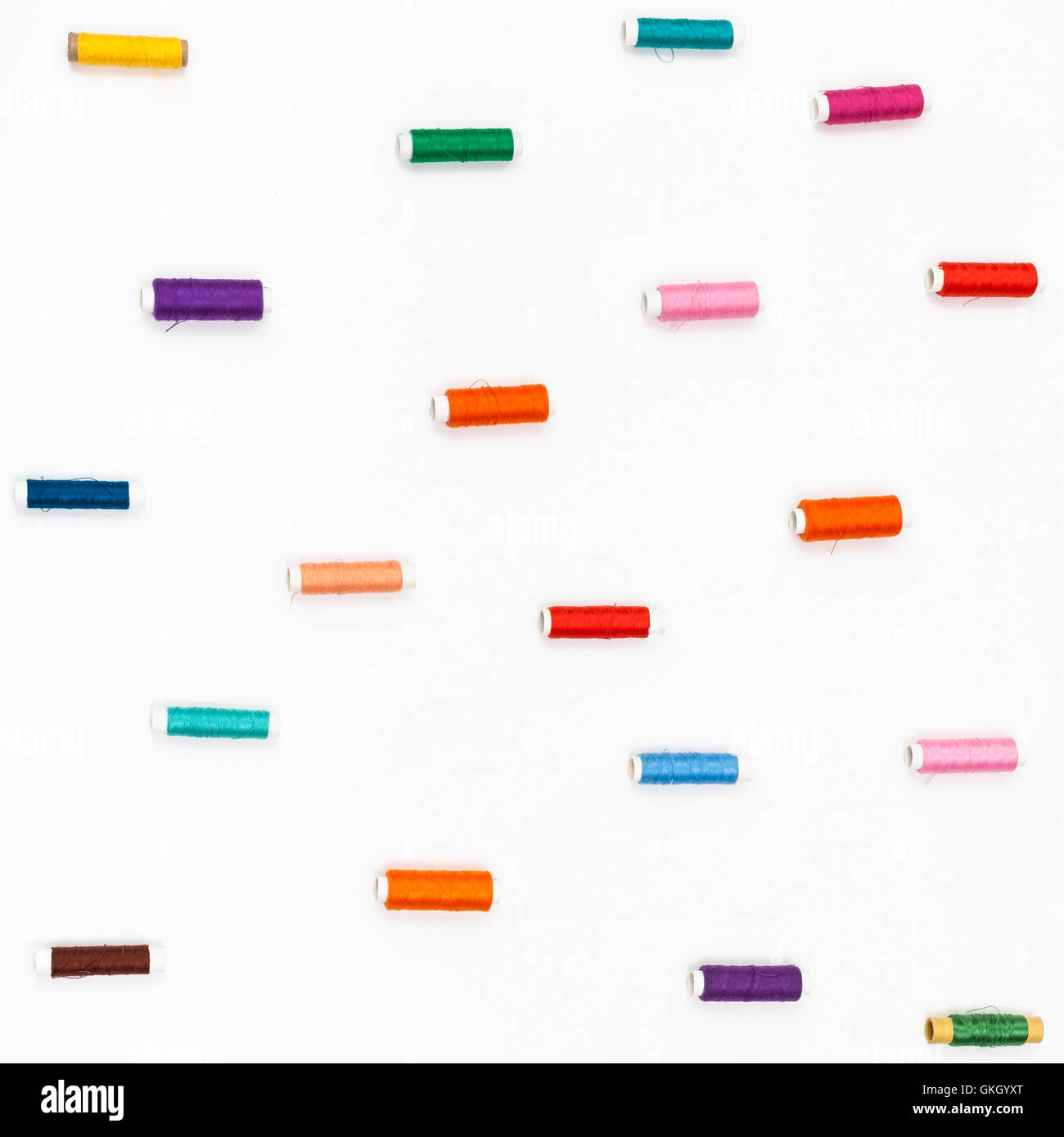spools of sewing color threads on white background Stock Photo - Alamy