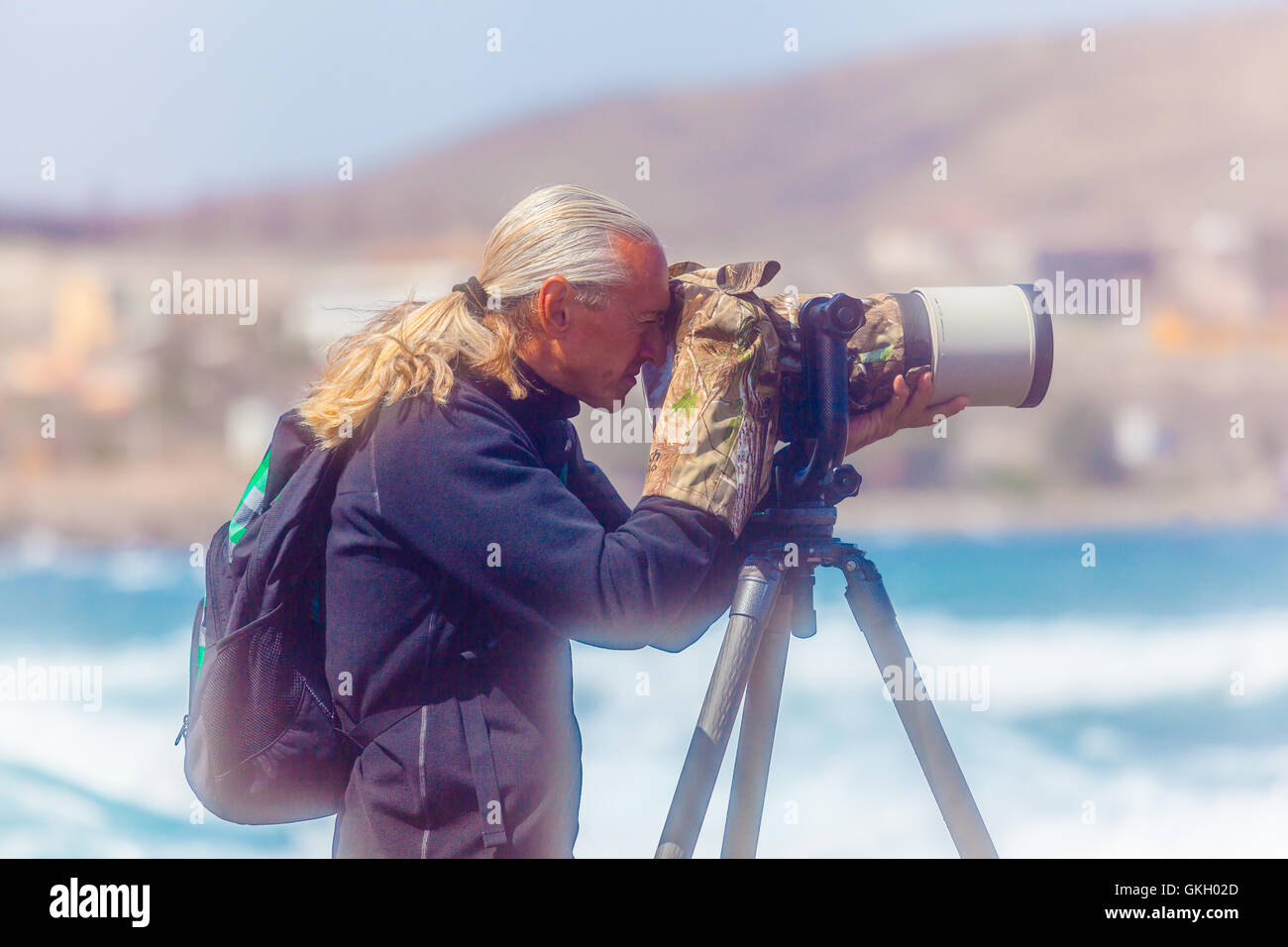 pro photographer taking pictures with a tripod on the beach Stock Photo ...