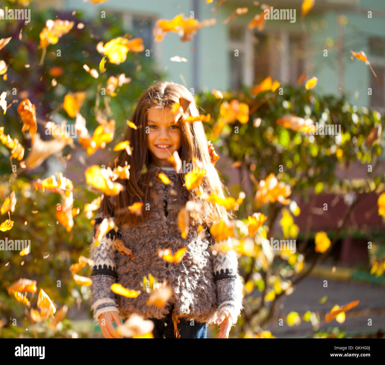 Young beautiful little girl with yellow leaves in autumn park Stock ...