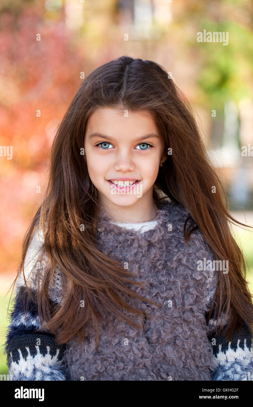 Close up portrait of a beautiful nine year old little girl in autumn park Stock Photo