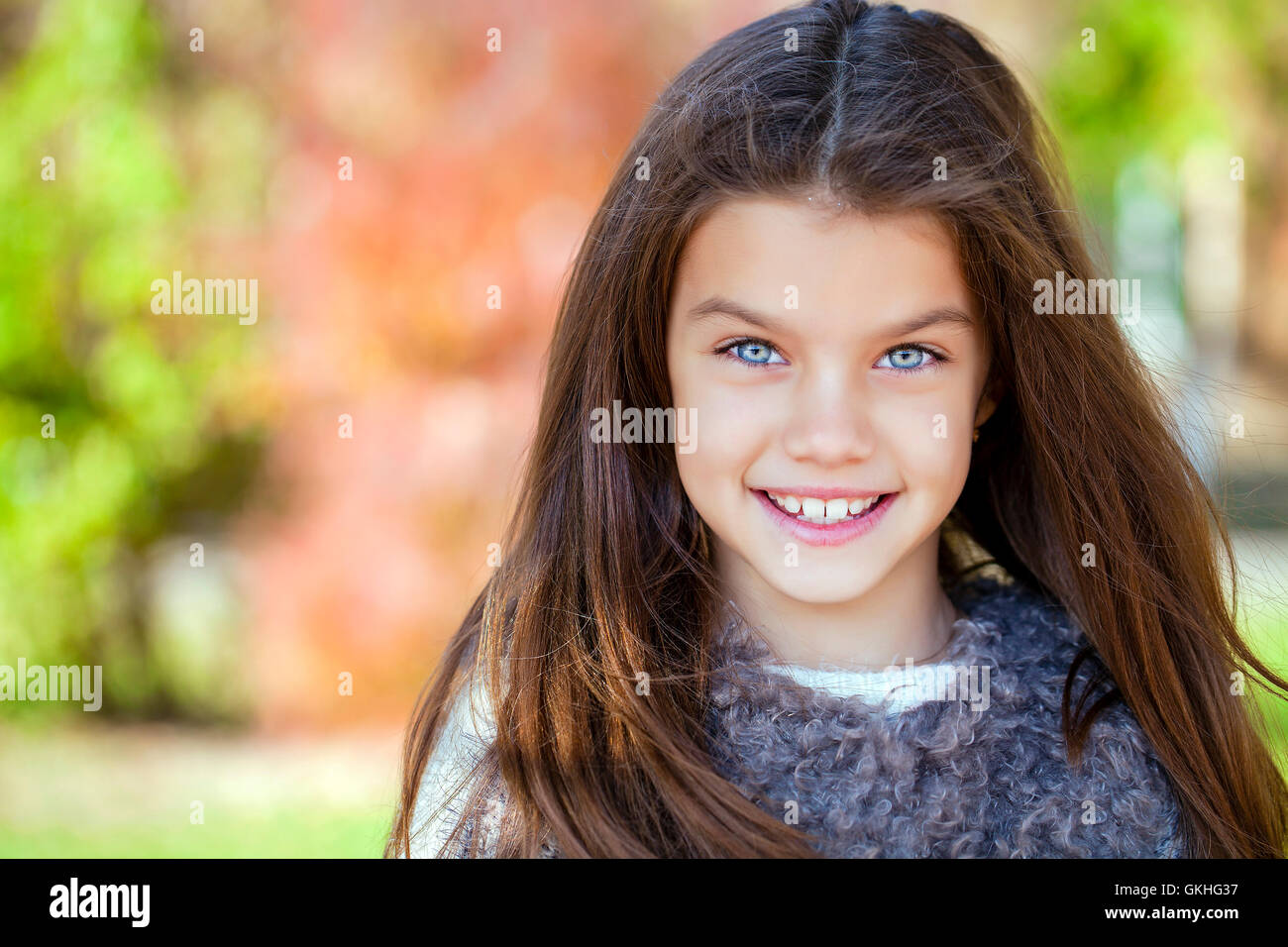 Close up portrait of a beautiful nine year old little girl in autumn park Stock Photo