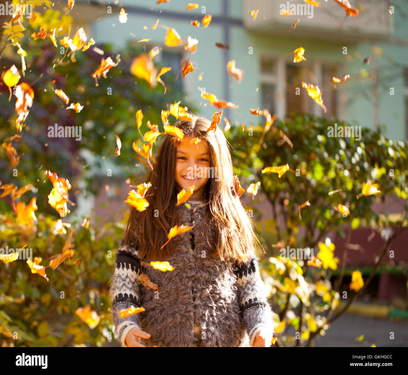 Young beautiful little girl with yellow leaves in autumn park Stock ...