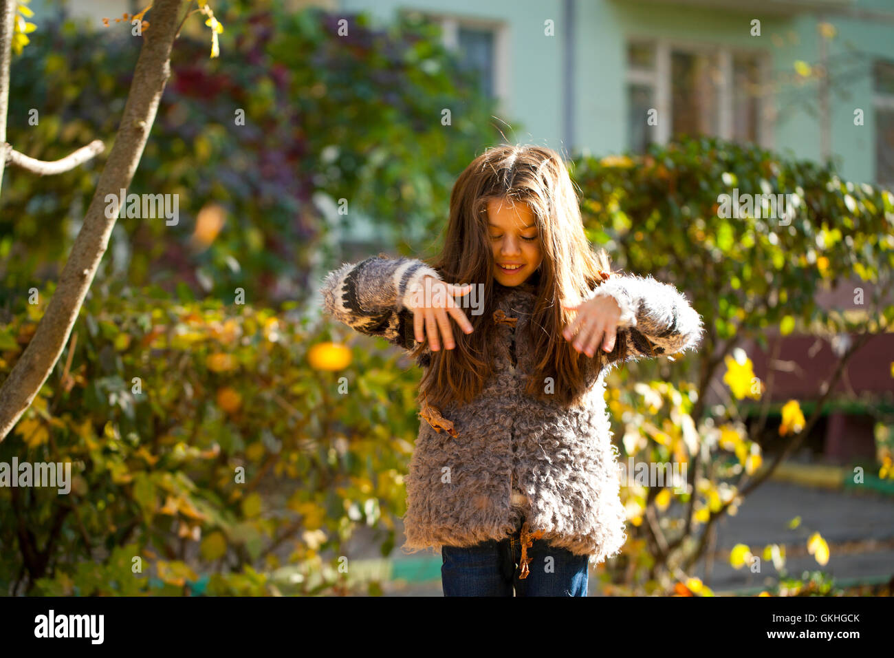 Young beautiful little girl with yellow leaves in autumn park Stock ...