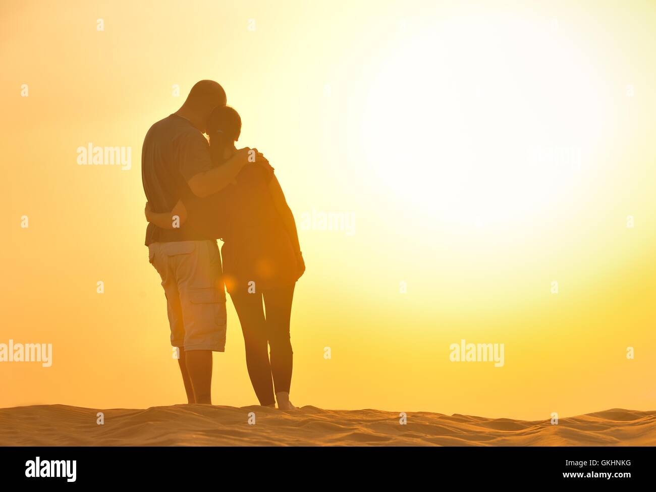 couple enjoying the sunset Stock Photo - Alamy