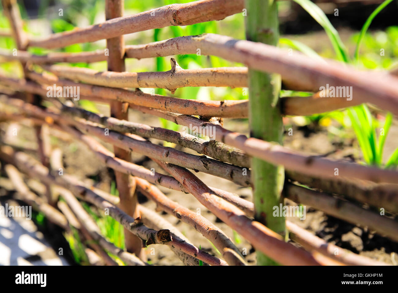 Fence from wooden twigs as a rural background Stock Photo - Alamy