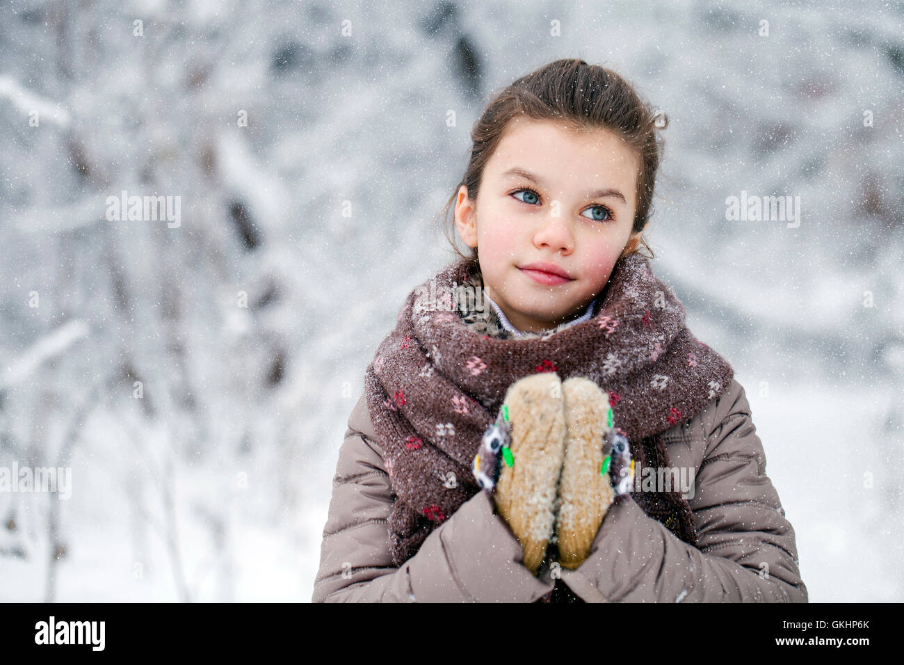 Little Girl Posing In Winter Clothes Over White Stock Photo
