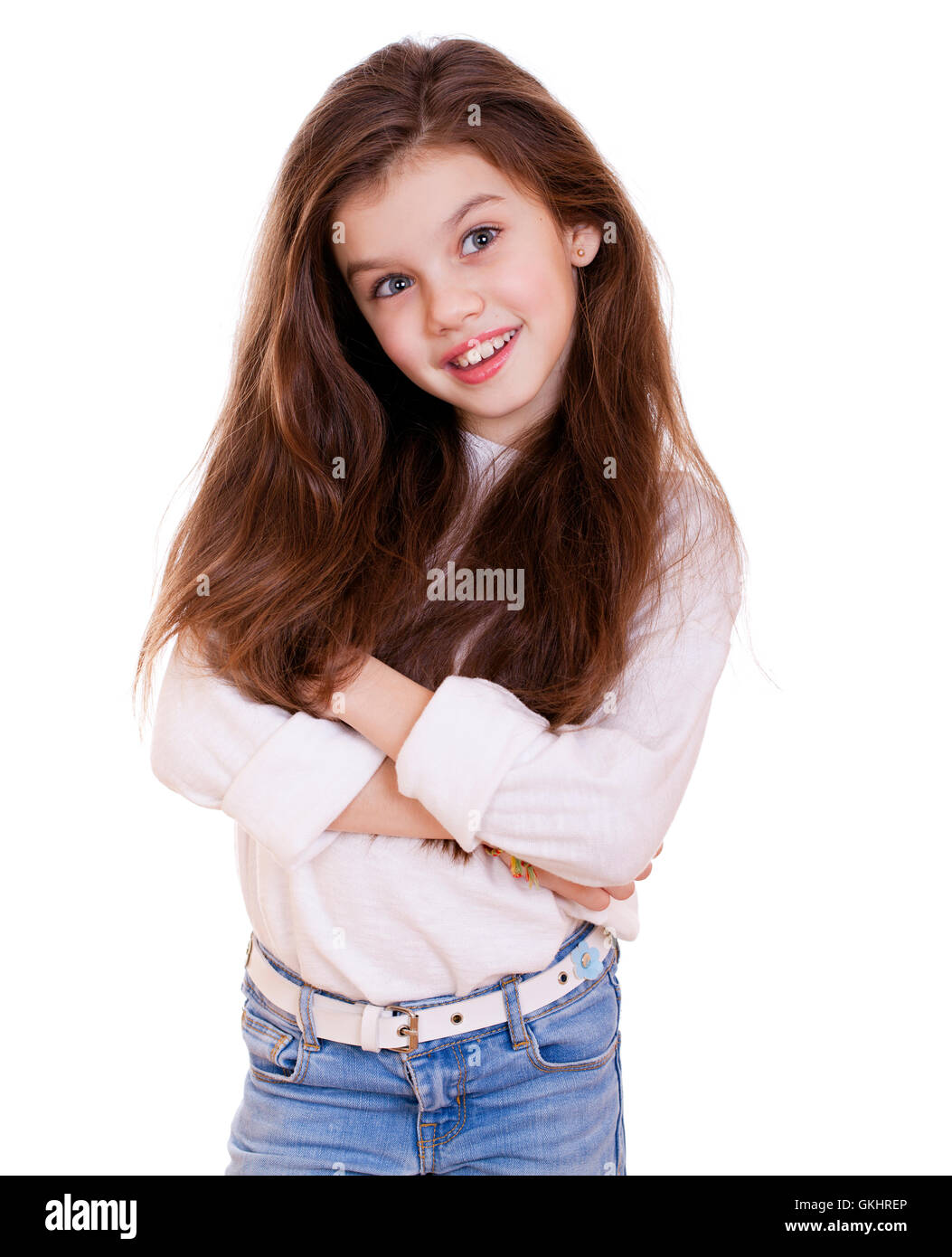 Portrait of a charming little girl smiling at camera, isolated on white ...
