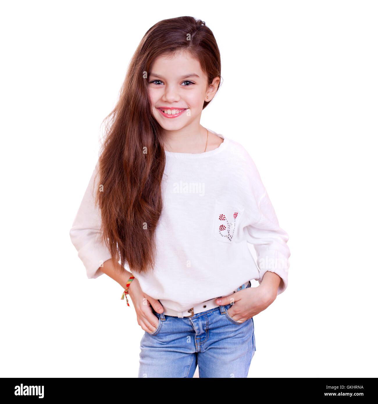 Portrait of a charming little girl smiling at camera, isolated on white ...