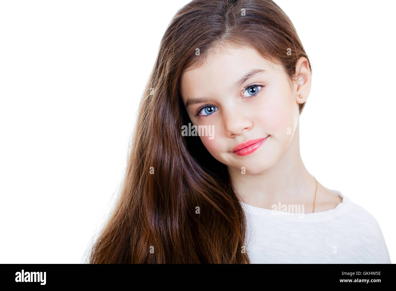 Portrait of a charming little girl smiling at camera, isolated on white ...