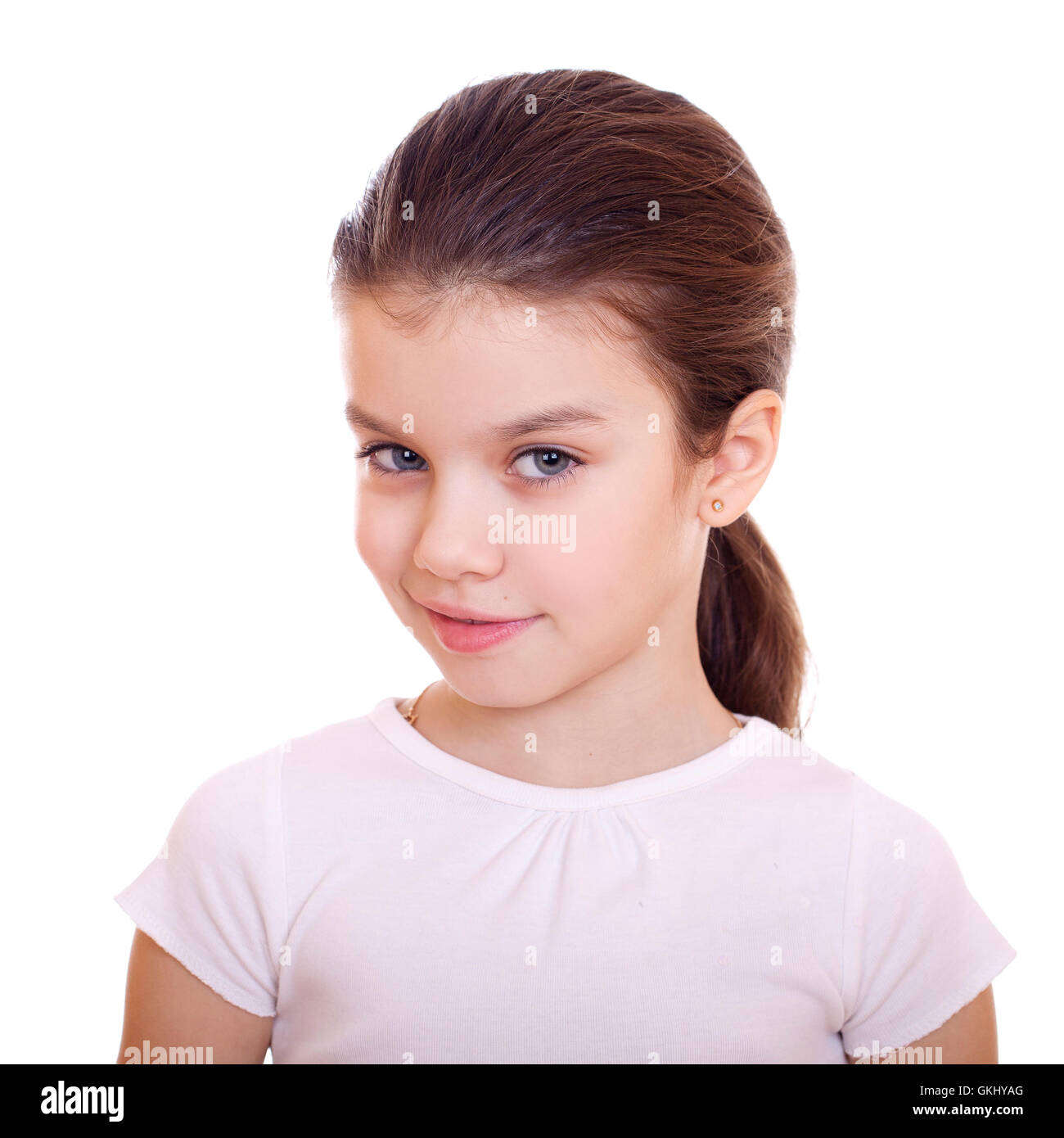 Portrait of a charming little girl smiling at camera, isolated on white ...