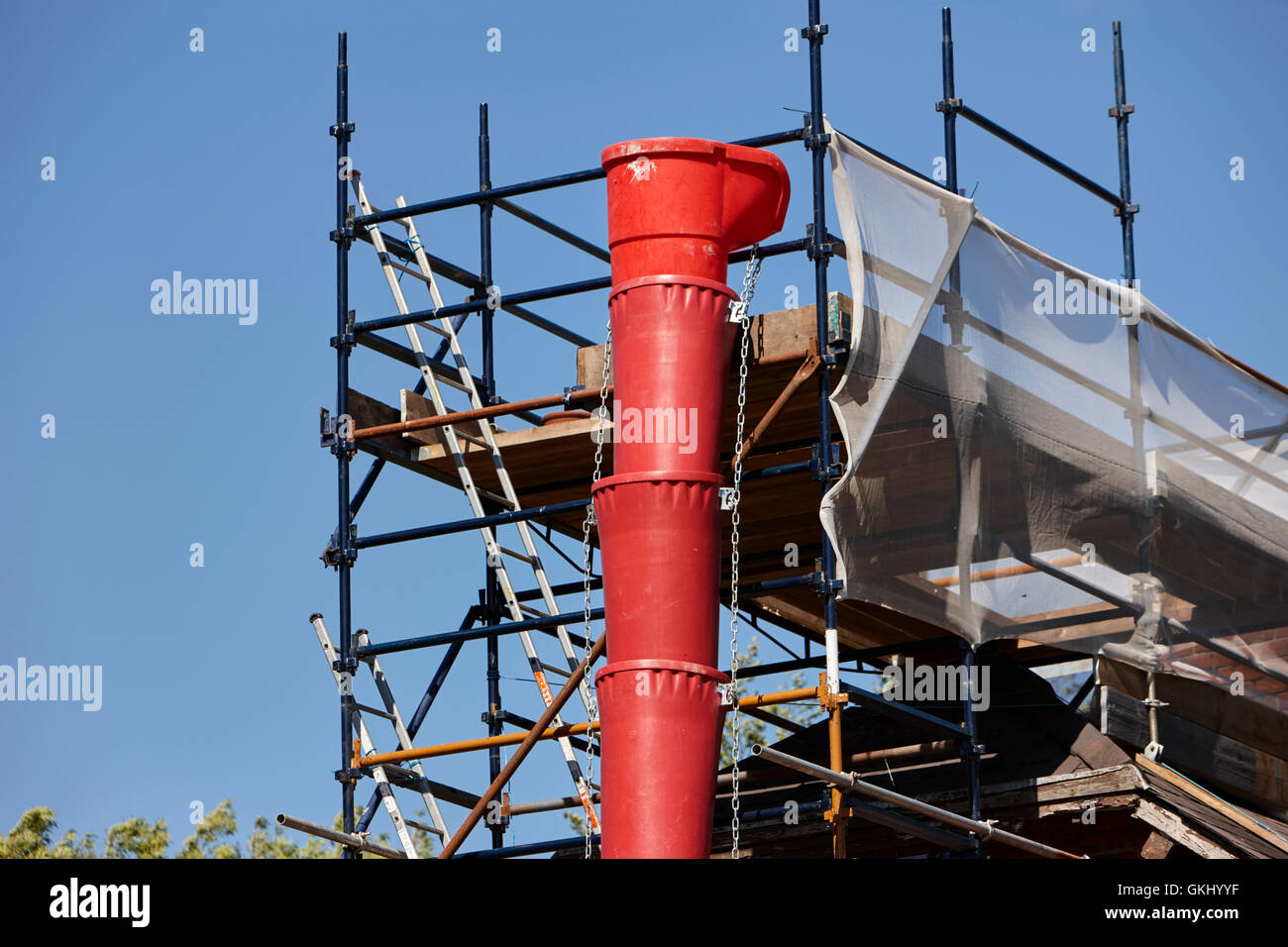 plastic rubbish chute attached to scaffolding on house extension in the uk Stock Photo Alamy