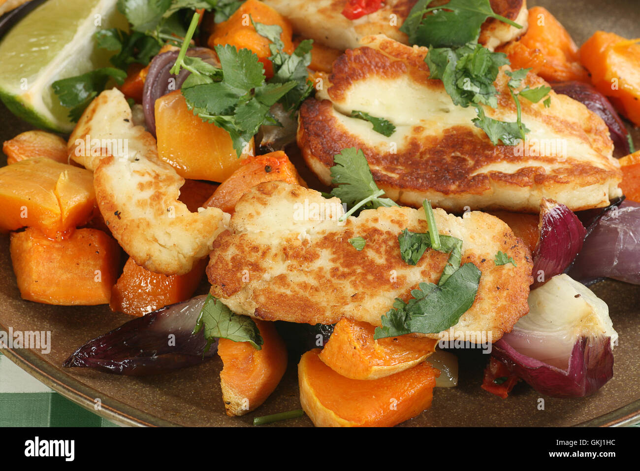 grilled halloumi cheese with roast sweet potato and red onion Stock Photo