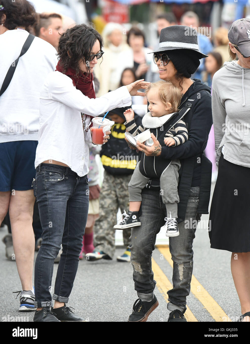 Sara Gilbert and Linda Perry take their son Rhodes to the Farmers