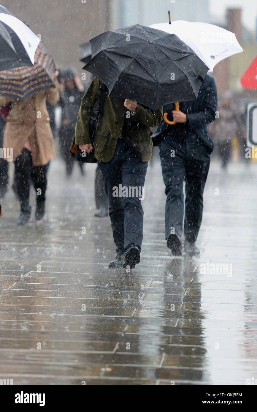 Commuters at London Bridge battle through wind and rain during the morning rush hour  Featuring: Atmopshere Where: London, United Kingdom When: 31 May 2016 Stock Photo