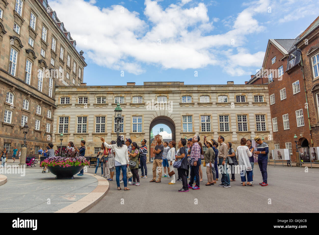 Asian tourists guided in front of danish parliament, Copenhagen Stock Photo