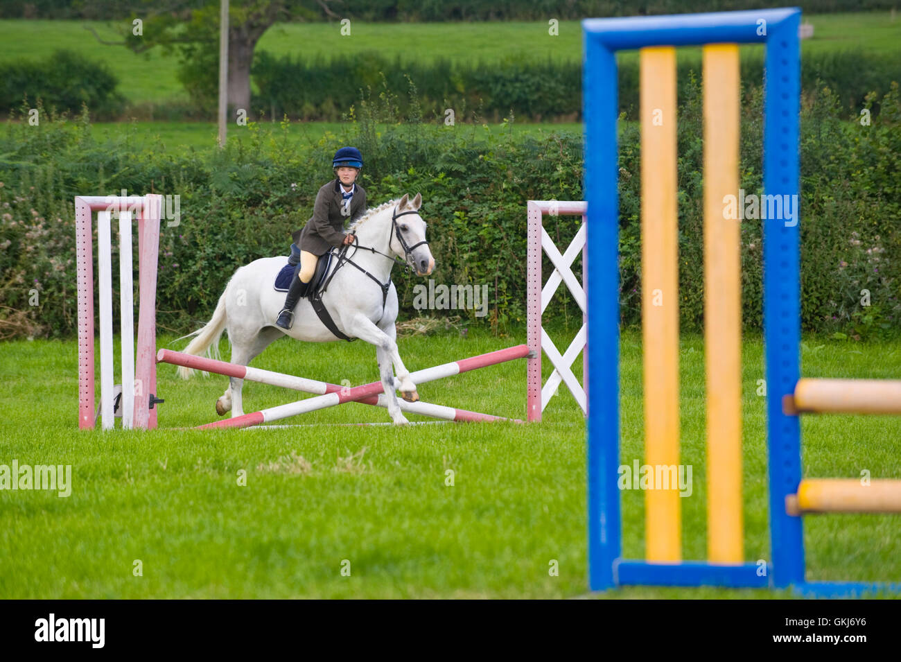 Teenage girl show jumping on her pony at Llanigon YFC Show 2016 nr Hay-on-Wye Powys Wales UK Stock Photo