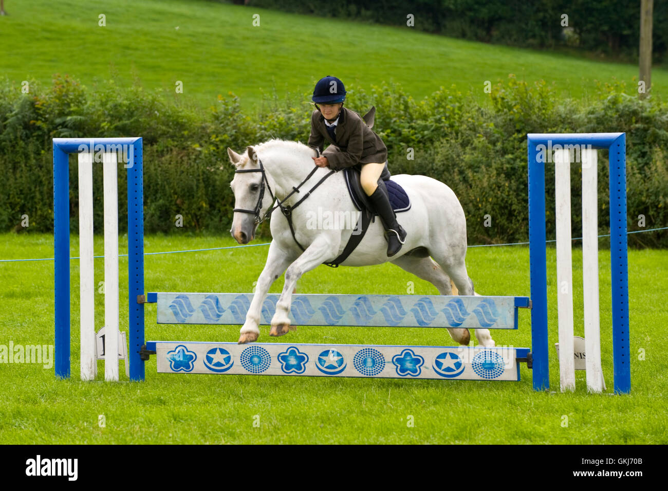 Teenage girl show jumping on her pony at Llanigon YFC Show 2016 nr Hay-on-Wye Powys Wales UK Stock Photo