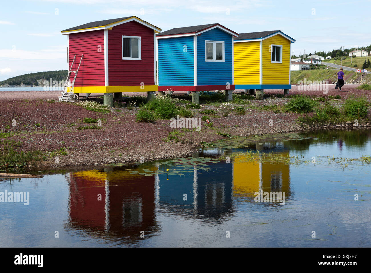 Colourfully Painted Cabins Reflecting In A Pond At Heart S Stock